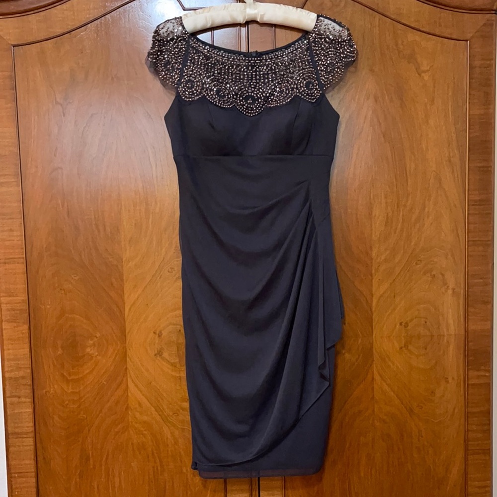 Escape Dark gray dress with beaded neckline.